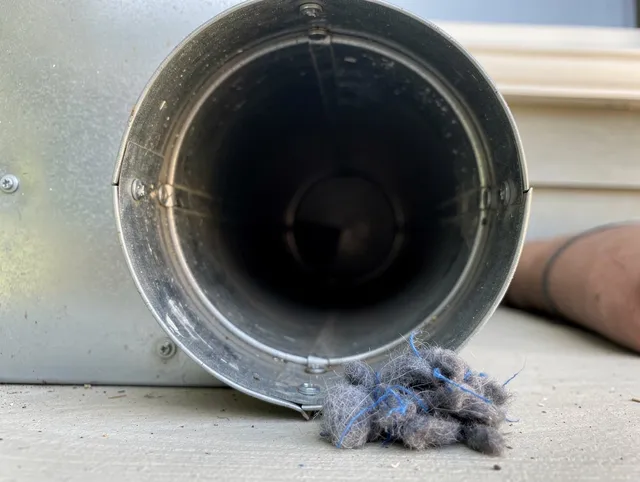 Suffield Dryer Vent Cleaning technician using specialized equipment to clear severe dryer vent blockage in Suffield